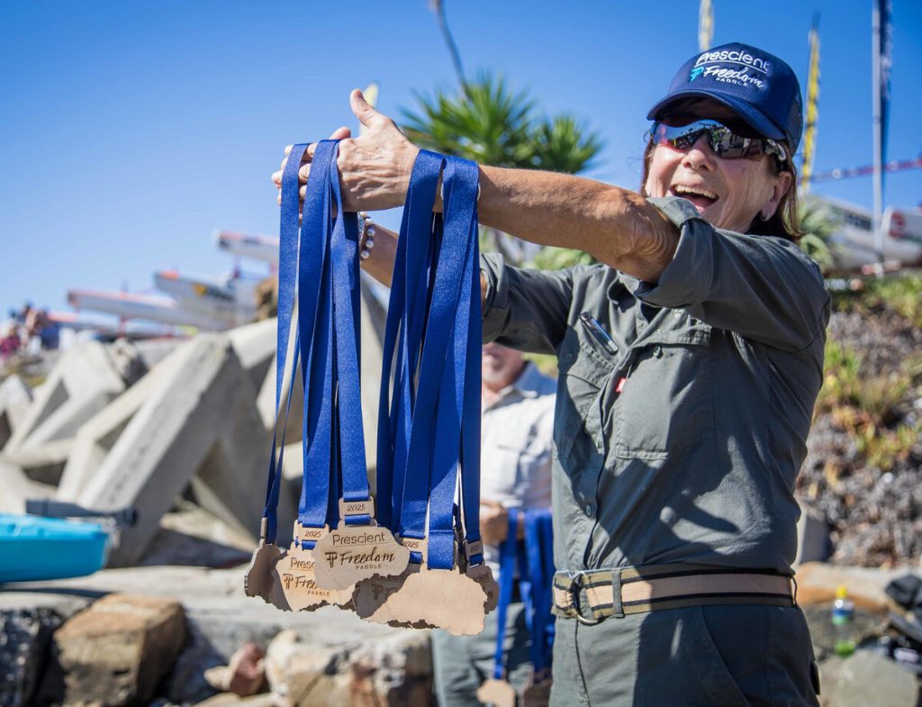 A SANParks Honorary Ranger handing out medals at the 2025 Prescient Freedom Paddle finish line. Photo: Graham Daniel/Prescient Freedom Paddle/Gameplan Media