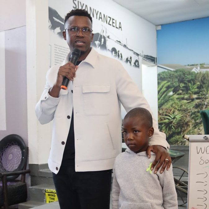 Phinius Sebatsane brings Inqm Masebe (8) on stage as a reminder of the inner child in need of healing
