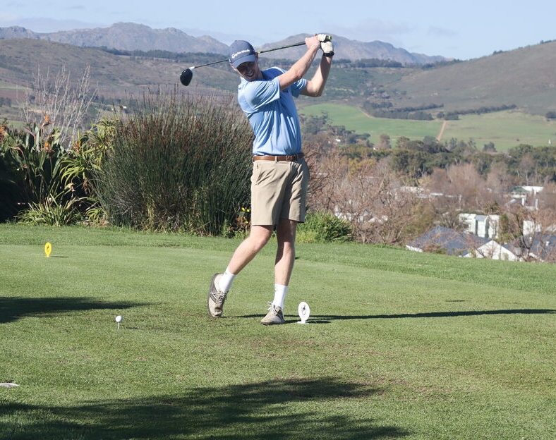 Liam Whitfield swings with great form at the Ubuntu Golf Day at Erinvale Golf Club.