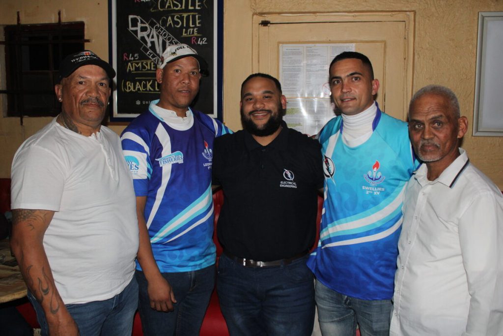 At the handover (from left) are coach Nico Lewis, first-team captain Germaine Simons, Roy Herbert of CHE Electrical Engineering, second-team captain Duncan McLeod and head coach Anwar Josephs.