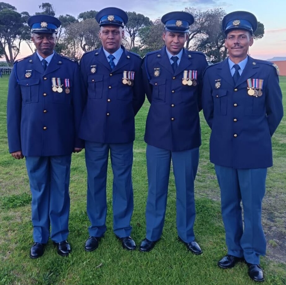 Four Somerset West police officers with their 20-year service medals