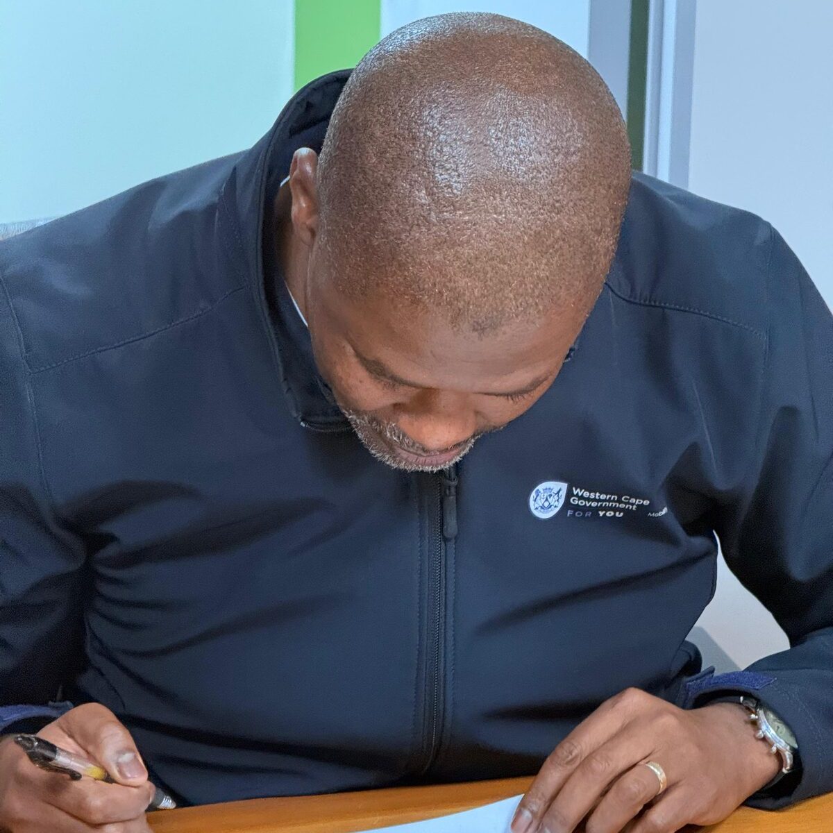 Isaac Sileku signing court documents for contempt proceedings against taxi operators
