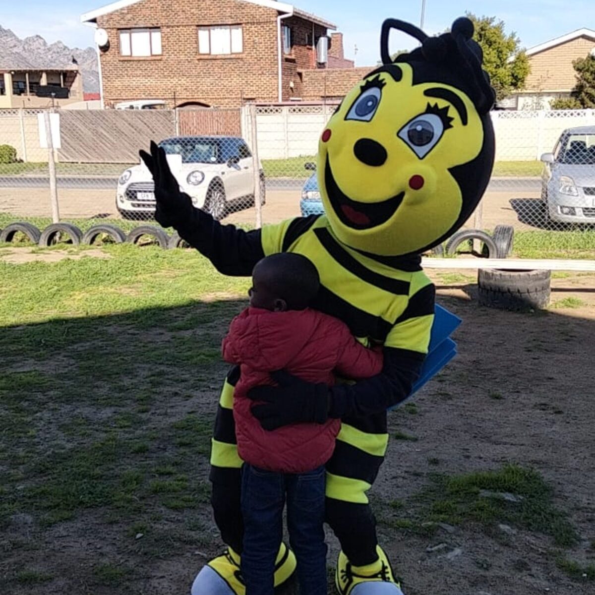 Liam Virgil Mongoka hugs City library mascot LiBee at Easy2learnkids mobile library launch.