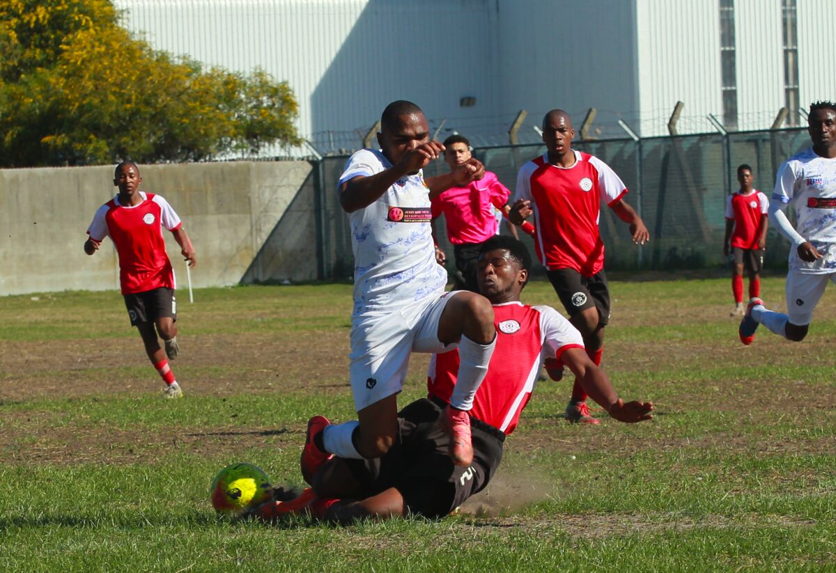 Lutando Mpokotya of Two for Joy FC is on the receiving end of an illegal tackle by Vuyolwethu Wawu of Valencia FC during a Safa Cape Town Coke Cup match played in Langa on Sunday (24 August). Two for Joy, a Lwandle-based team affiliated to the Helderberg Local Football Association, were 1-0 victors and advanced to the quarter-final of the knockout competition. Photo: Rashied Isaacs