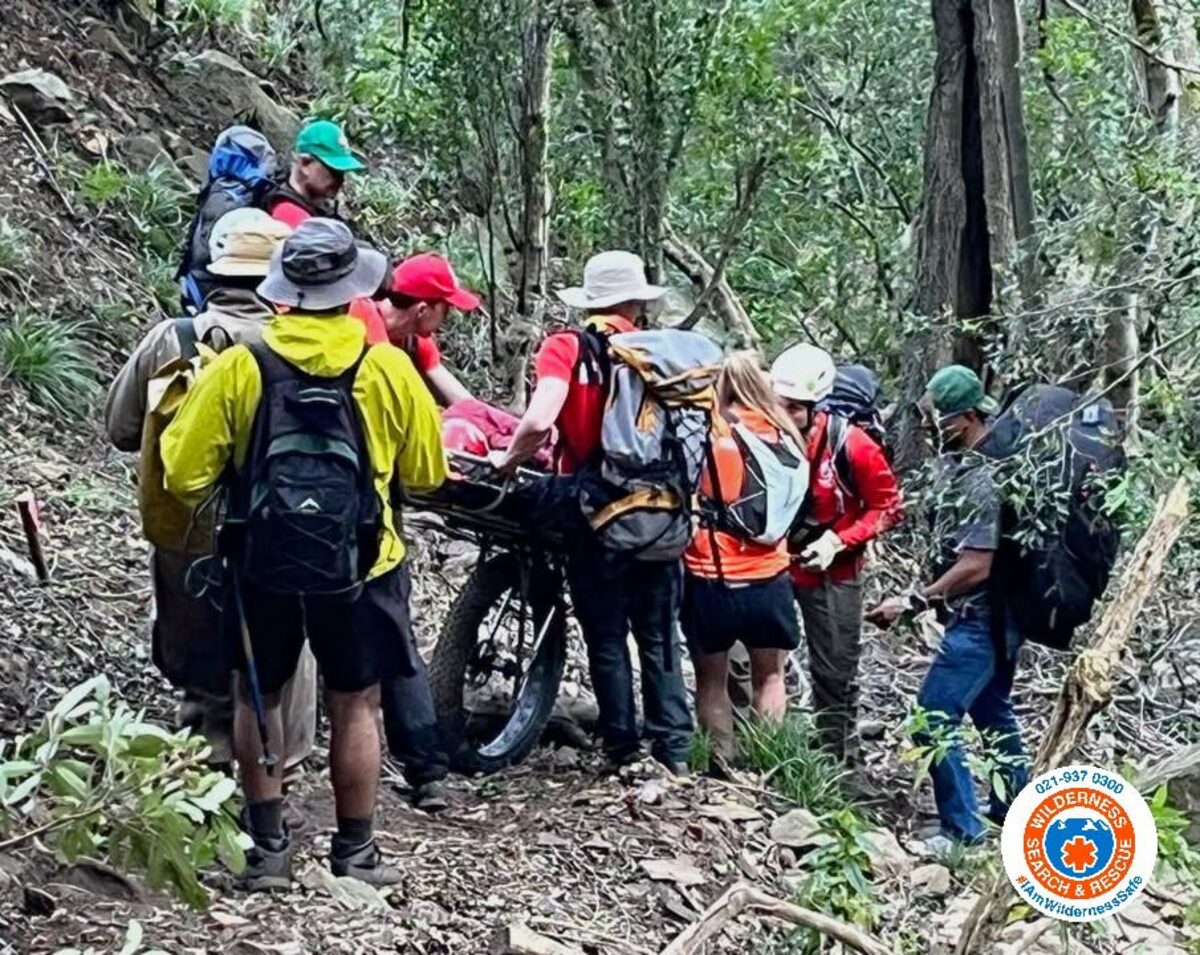 WSAR teams carry injured hiker on stretcher down West Peak trail at Helderberg Nature Reserve