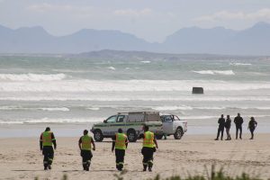 Desperate search continues for two men swept away at Strand Beach