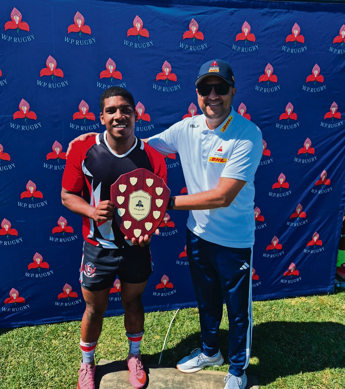 Raithby Universals Captain Joshua Thomas with a WP Representative.