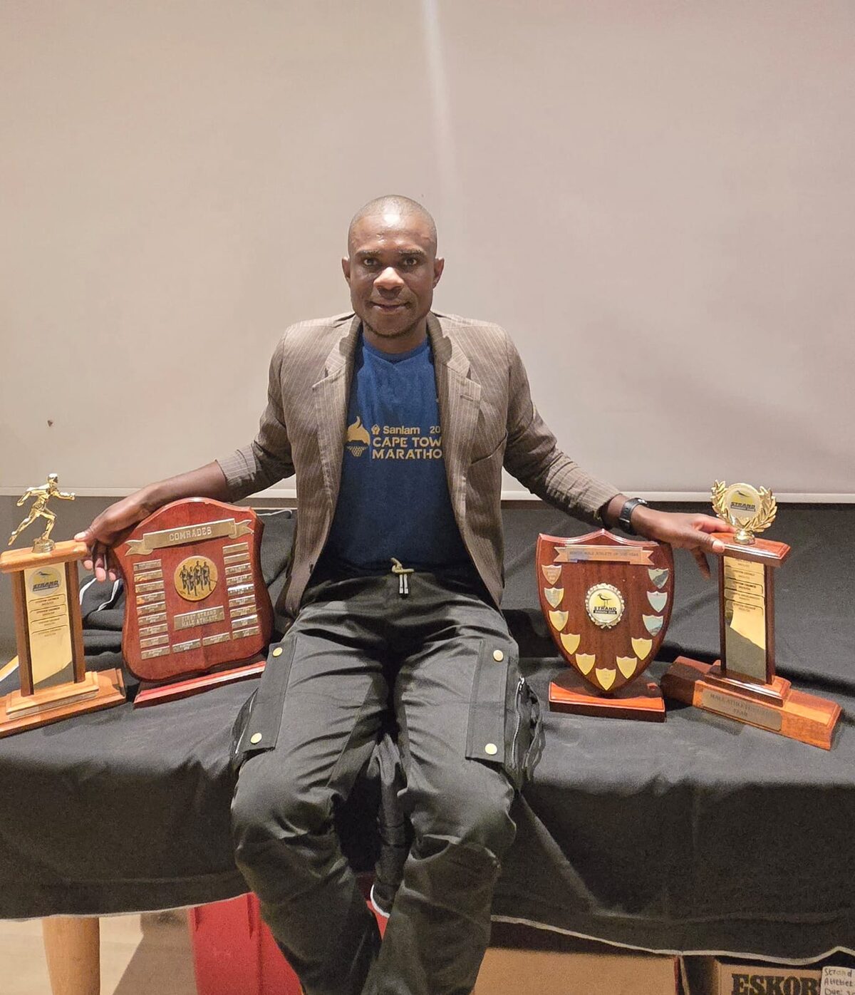 Steven George with the trophies he received at the awards ceremony.