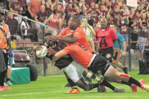 Diving for the line as defenders desperately try to hold on