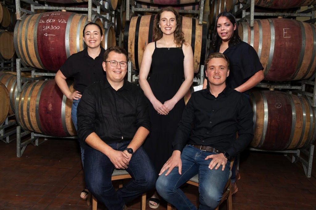 The 2025 Diners Club Young Winemaker of the Year finalists (behind from left) Daniela Jansen (Saronsberg), Gerné van Zyl (Chamonix) and Narissa Pieters (Rustenberg). Front: Marnich Aucamp (Stellenbosch Vineyards) and Loïc du Toit (De Wetshof).