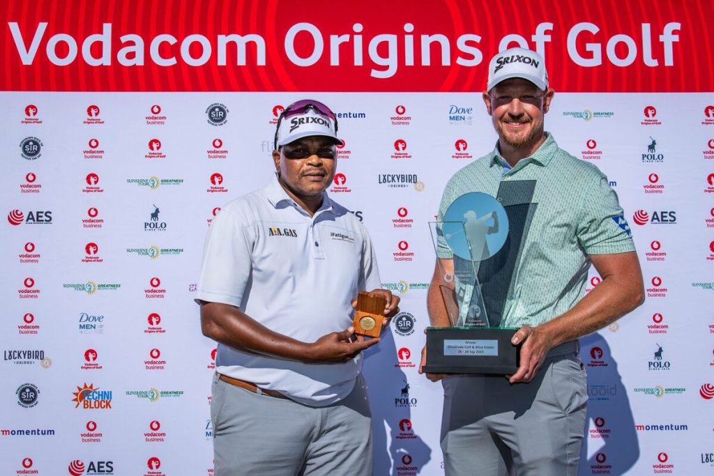 Jacques Kruyswijk (right) won his first Sunshine Tour title in the Cape and he got engaged in the Cape, so it seemed hardly surprising that a windy final round and a two-hole play-off should go his way as he won the Vodacom Origins of Golf at Devonvale Golf & Wine Estate on Sunday (28 September). In the tough conditions of a strong wind sweeping through the winelands, Kruyswijk beat George Coetzee with a par on the second hole of their play-off to claim the fourth Sunshine Tour title of his career. Pictured with Kruyswijk is his caddie, Terence Mngoma, who received a Sunshine Tour medallion for the winning caddie. Photo: Tyrone Winfield/Sunshine Tour