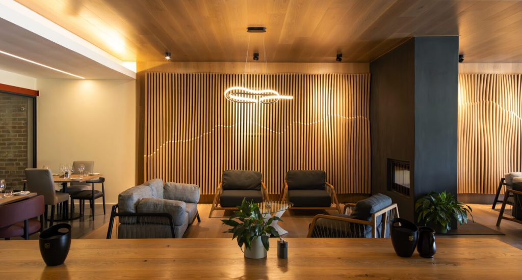 The newly refurbished wine tasting venue at Neil Ellis Wines showcases elegant interiors with inviting lounge-style seating.