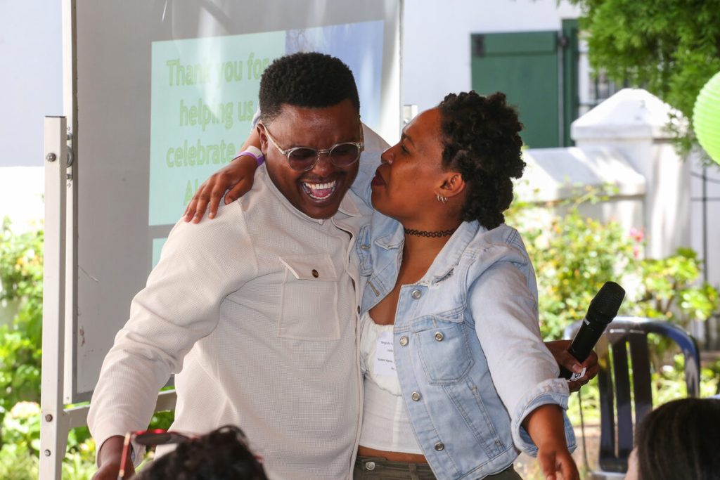 The event's master of ceremonies David Jantjies is embraced by Meagan Kammies.