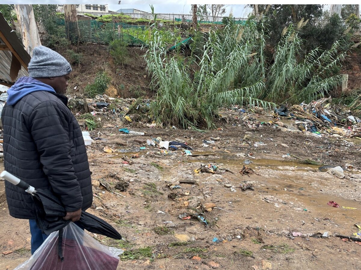 Simnikiwe Nkohla, standing in front of the now open space, which once housed his shack. Photo: Hlomla Mdala