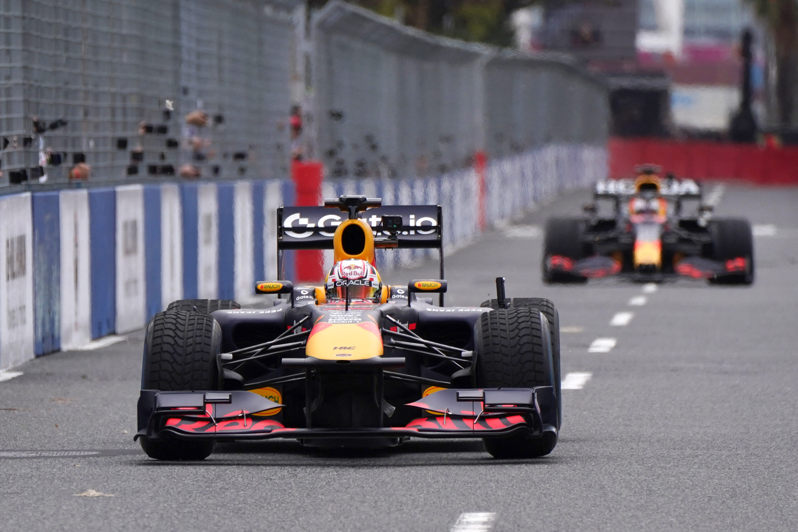 Red Bull Racing's Japanese driver Yuki Tsunoda (L) and Dutch driver Max Verstappen (R) drive during a demonstration run as part of the Red Bull Racing Show Run in Tokyo on April 2, 2025, ahead of the Formula One Japanese Grand Prix in Suzuka.