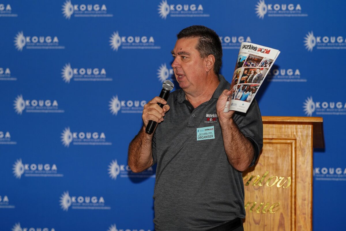 Andrew Binning, CEO, Inkanyezi Events speaking with a book in his hand.