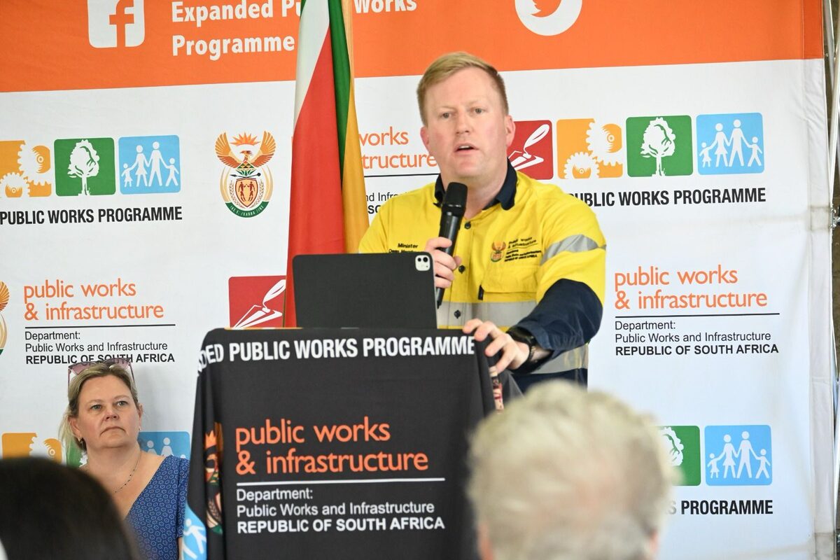 A picture Minister of Public Works and Infrastructure, Dean MacPherson speaking to a crowd of people.