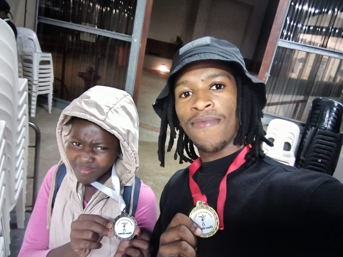 Yomelela Pongolo with her bronze medal, and her coach, Zolani Sibengile with his gold medal.