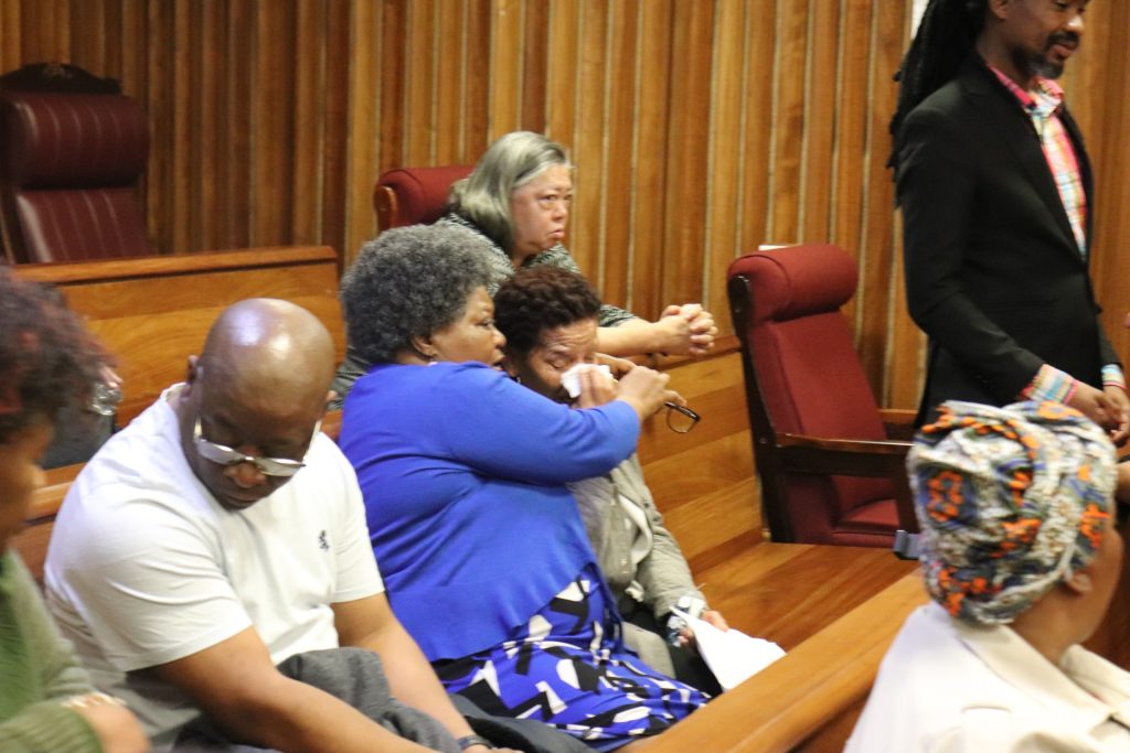 Nombuyiselo Mhlauli and Nomonde Calata consoling each other during Lukhanyo Calata's testimony.