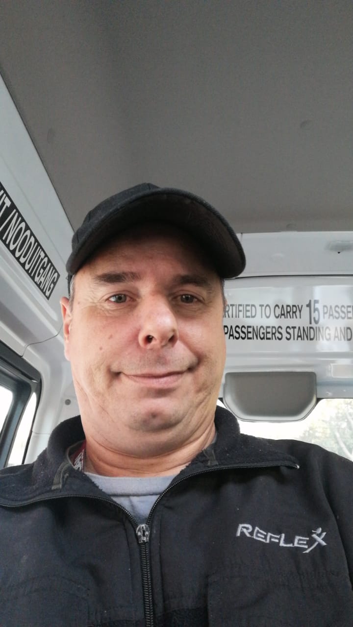 John Rautenbagh smiling at the camera.