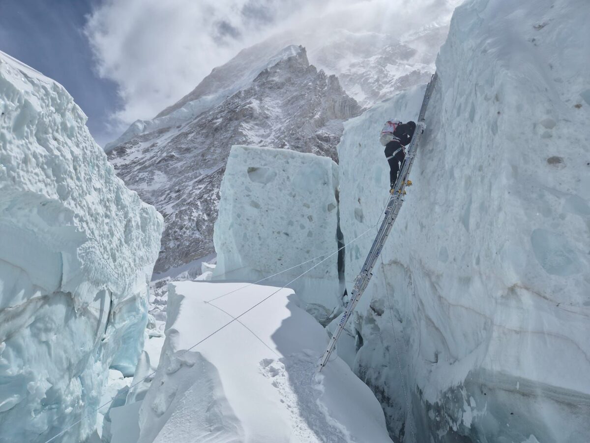 Zach Smith climbing on a ladder on  Mount Everest.