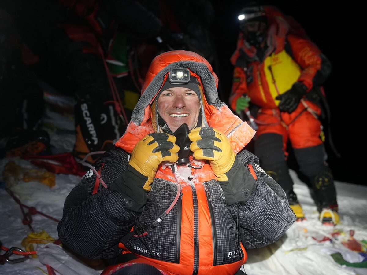 Zach Smith holding a large block of snow.