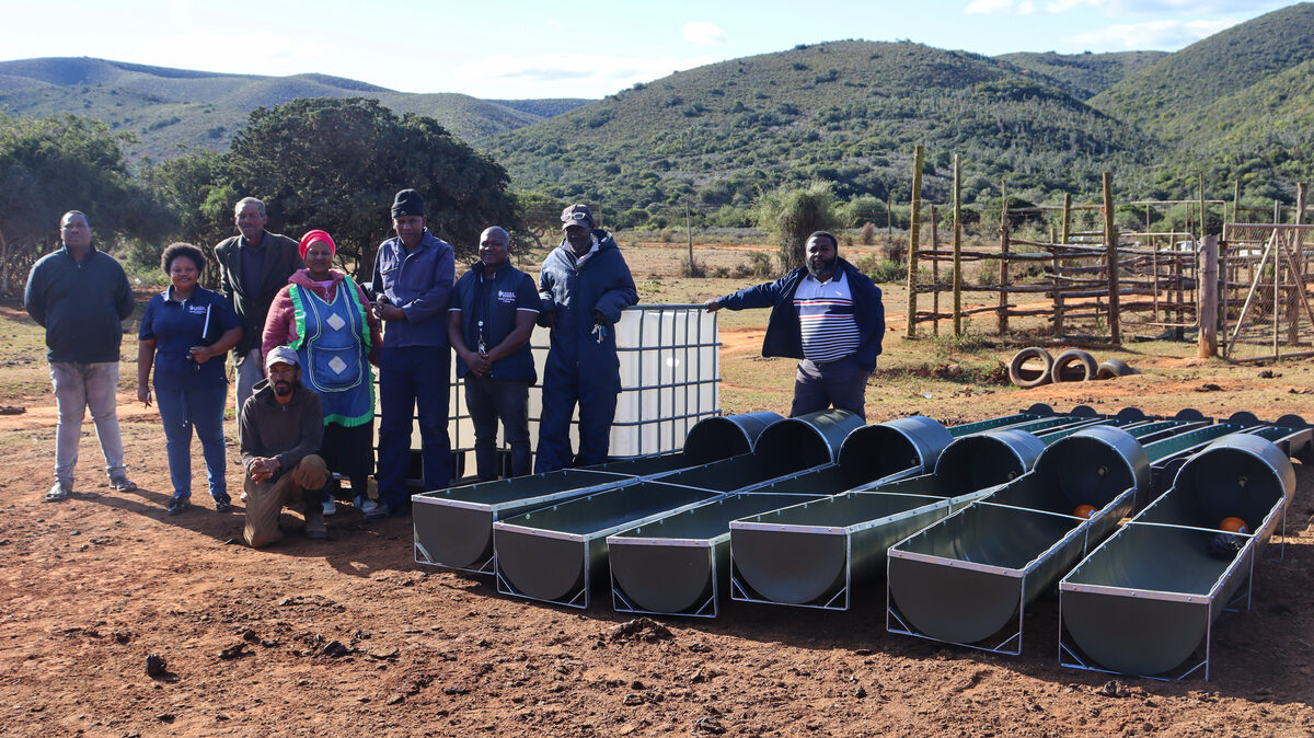 A group of people with farming equipment.