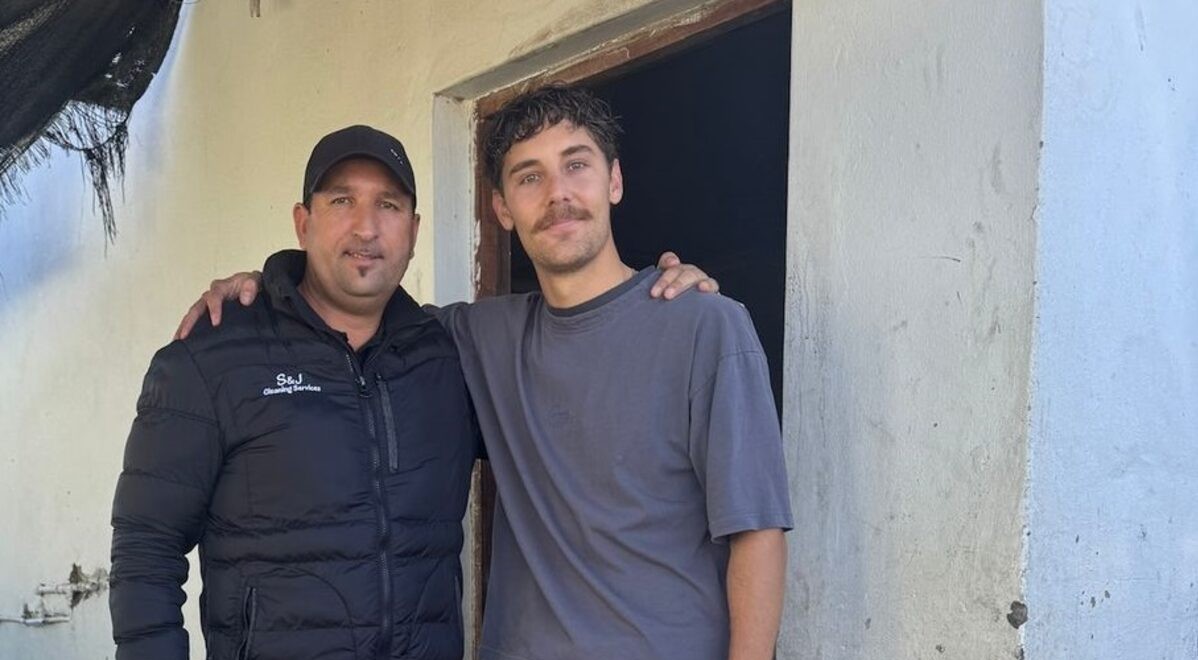 Jerome Visagie and Caskin White standing alongside each other with a house behind them.