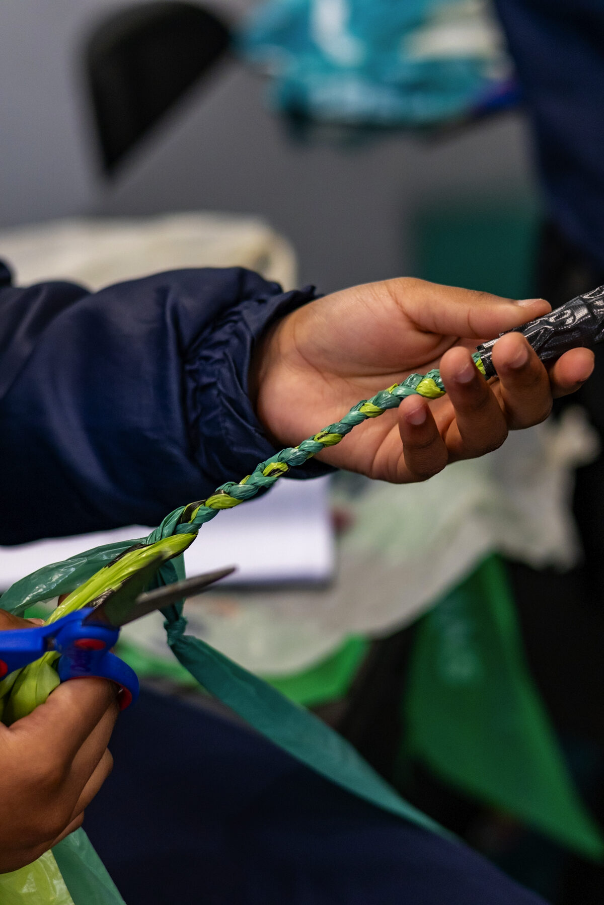 One of the learners crafting a skipping rope out of donated plastic bags.