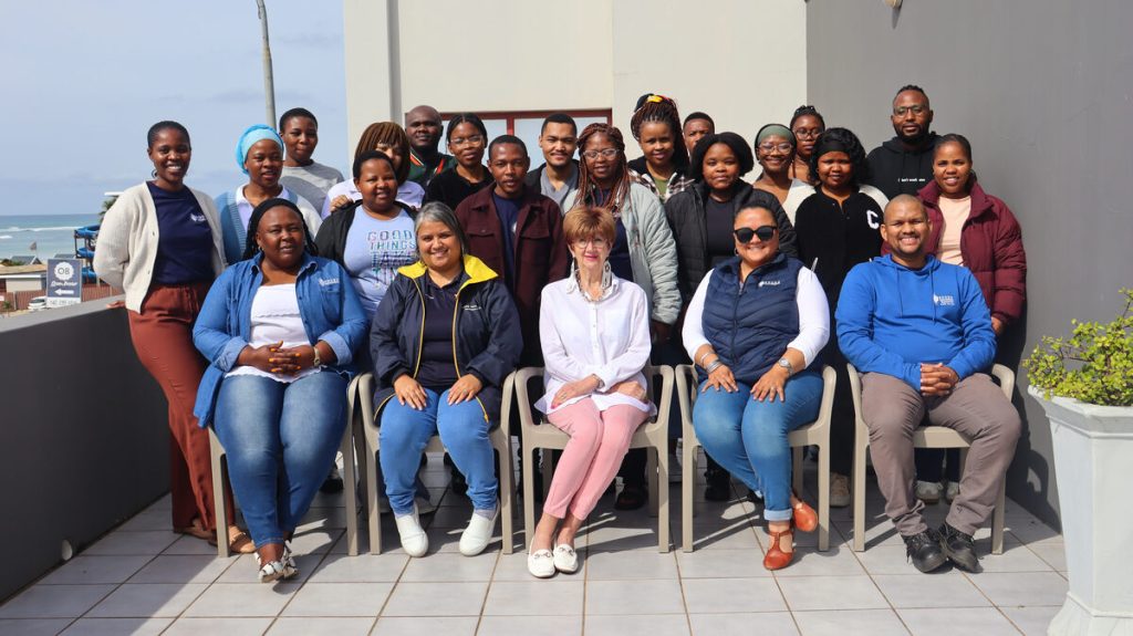 A group of people standing alongside each other.