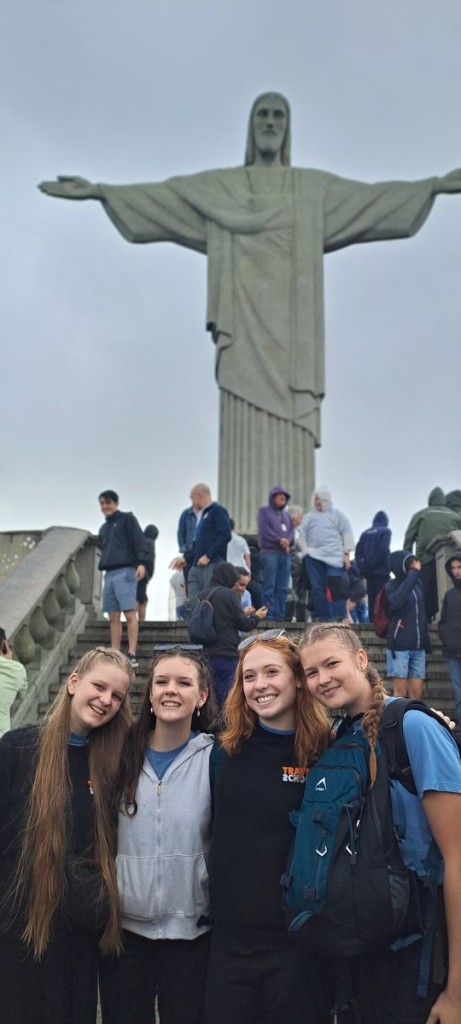 A group of learners standing in front of the Christ the Redeemer statue in Rio de Janeiro, Brazil.