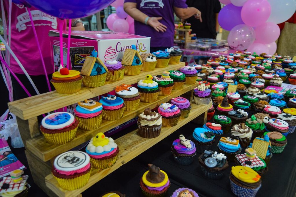 Beautifully decorated cupcakes.             on a table.
