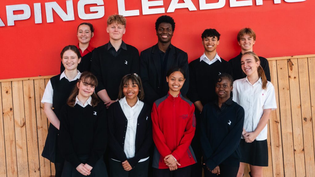 A group of learners standing alongside each other.