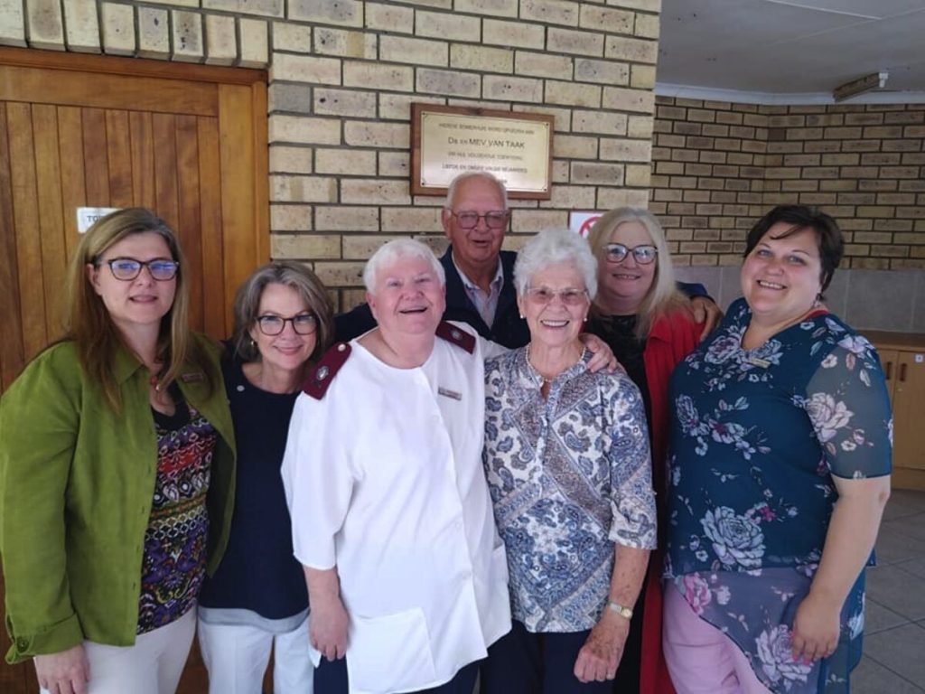 A group of people standing alongside each other.