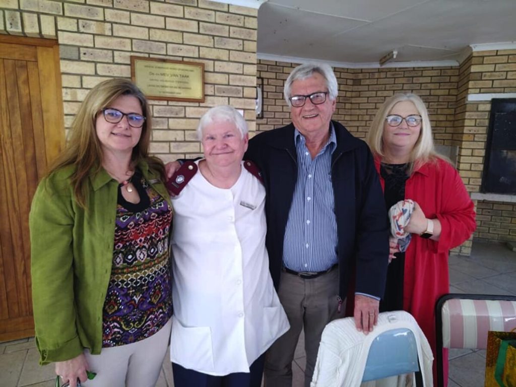 A group of people standing alongside each other.