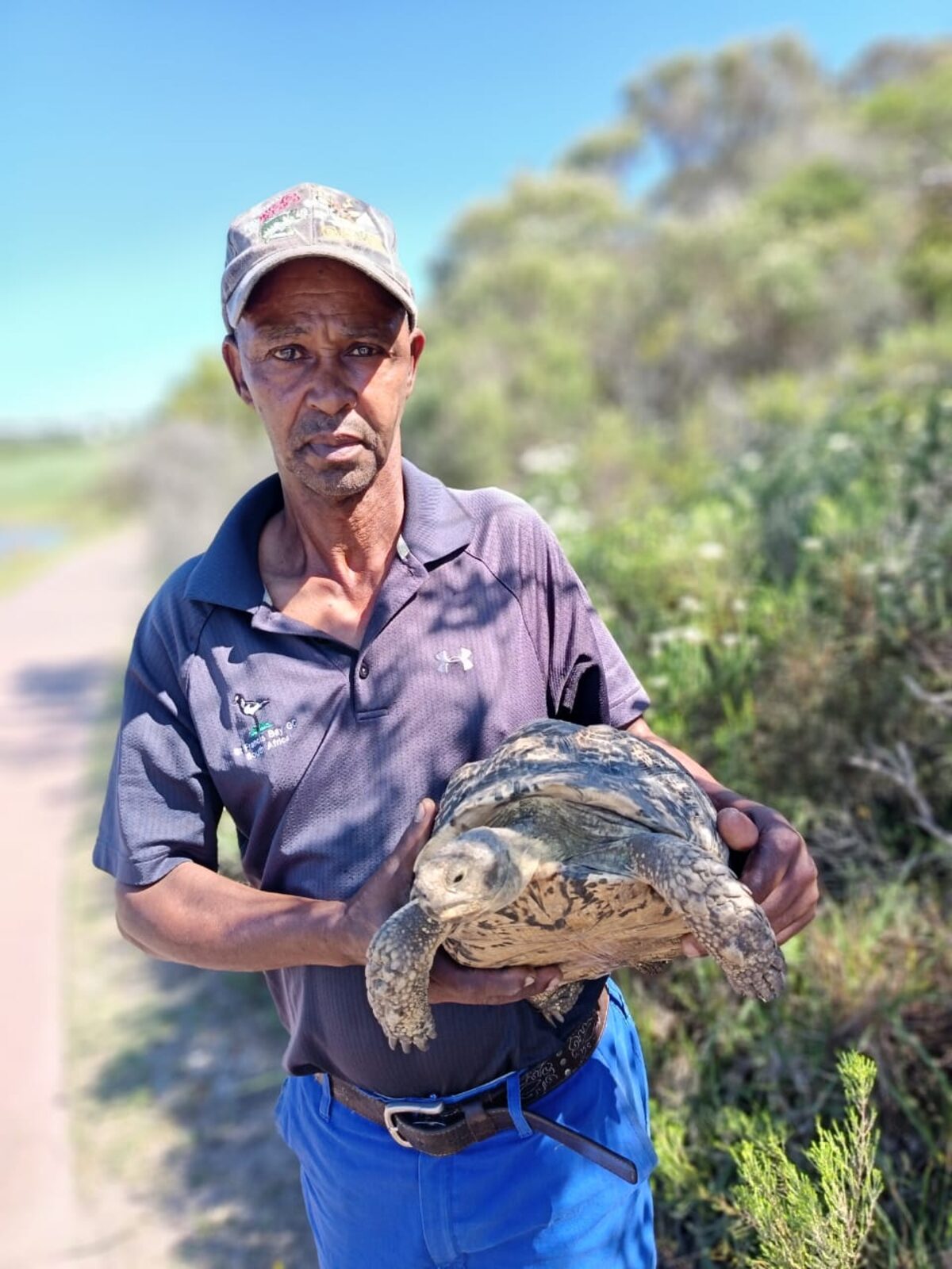 Nicky Miggles holding a tortoise.