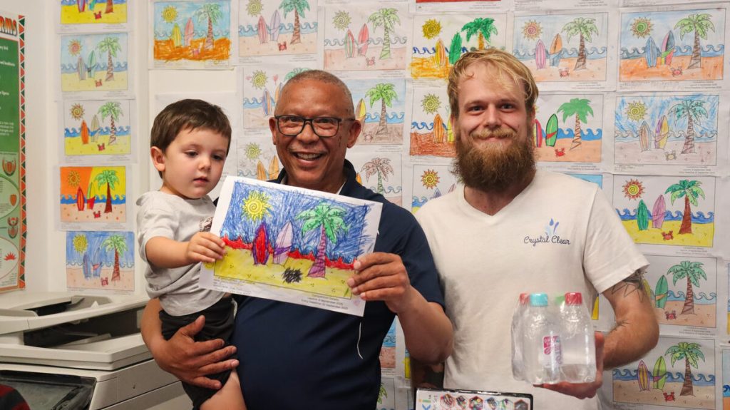 Aaric Euvrard receiving his prize from Deputy Executive Mayor Timothy Jantjes with Liam Kelbrick standing alongside them.
