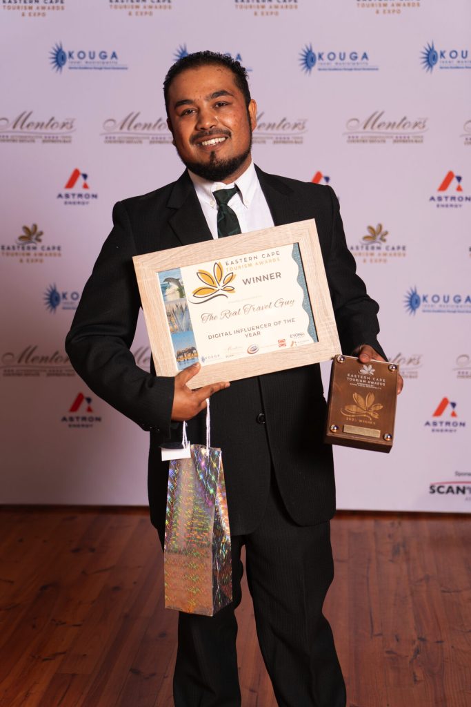 A man showcasing his award.