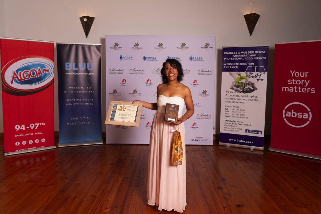 A women showcasing her award.