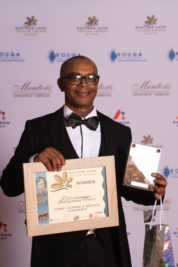 A man showcasing his award.