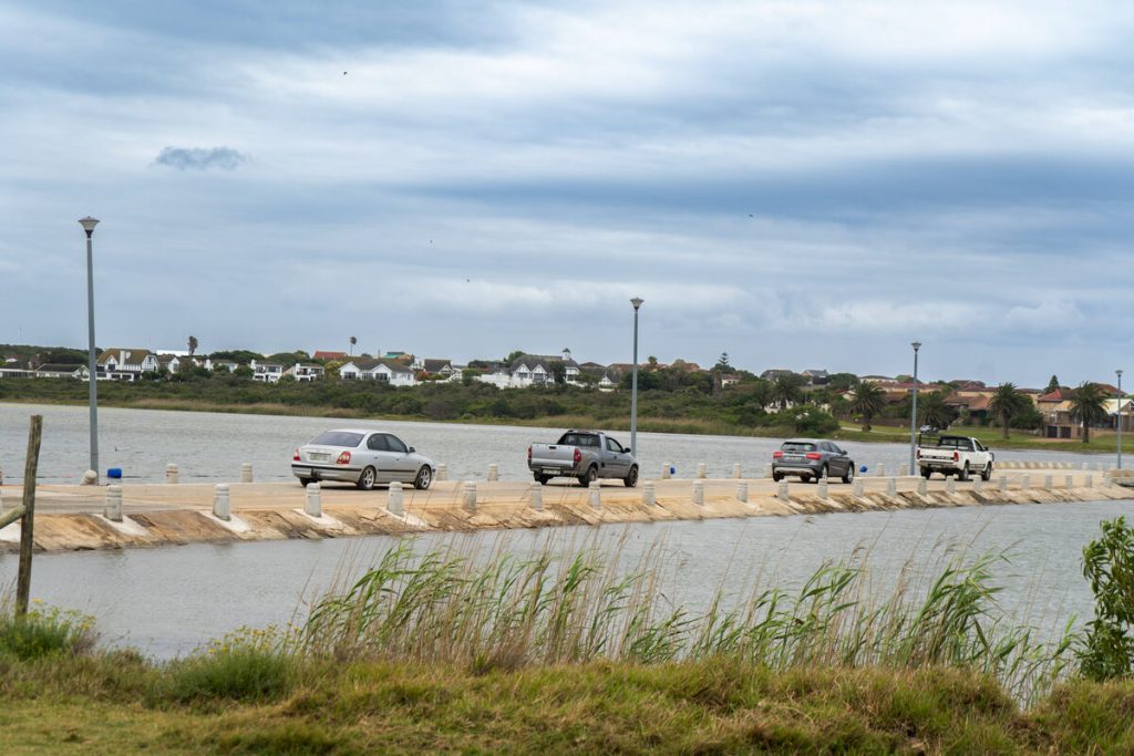 Cars travelling on the Seekoei Estuary Causeway.