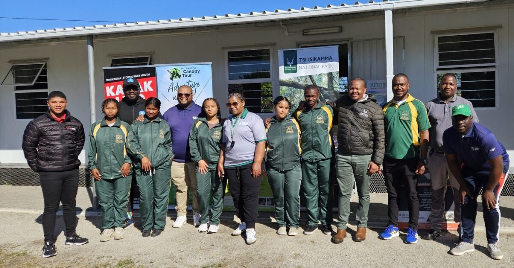 A group of people standing alongside each other.