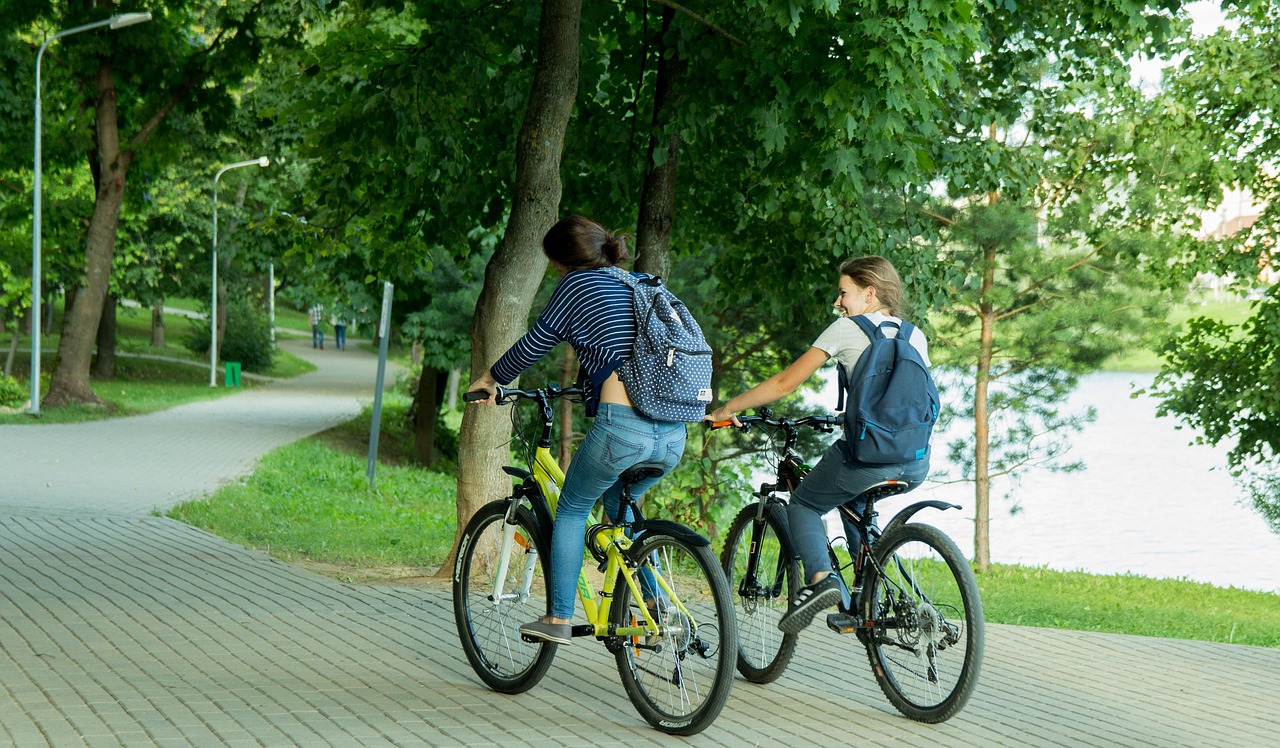 Two young people riding their bicycles.