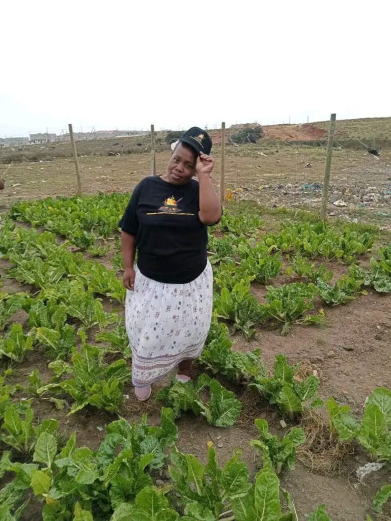 Amanda Dyantyi standing at the vegetable garden.