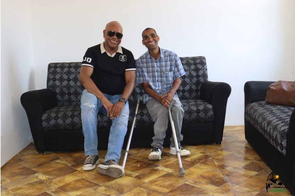 Edmond Venn and Jeremy Honeybrook sitting alongside each other on a couch.