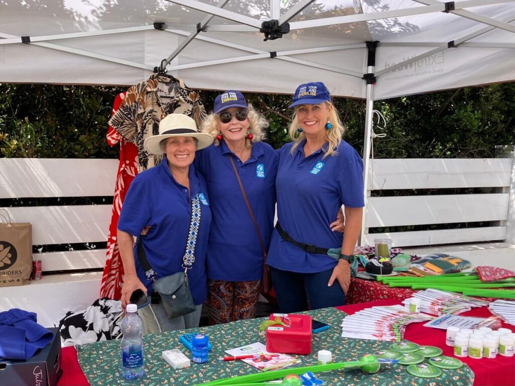Sheena Ruth, Susan Rae Fox and Jenny Pike standing at a stall.