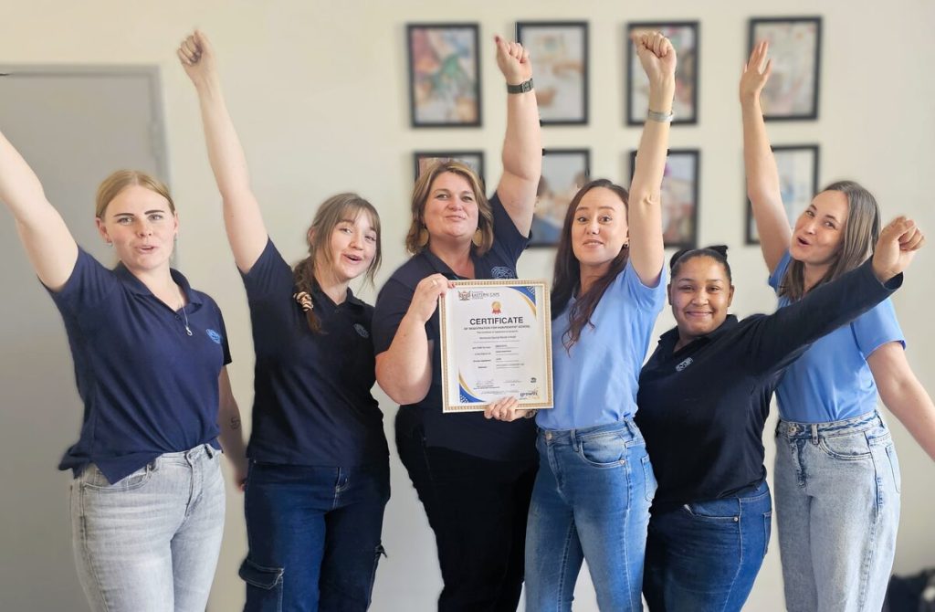 A group of people standing alongside each other.