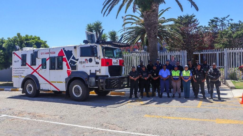 The Red Ants employees standing alongside a truck.