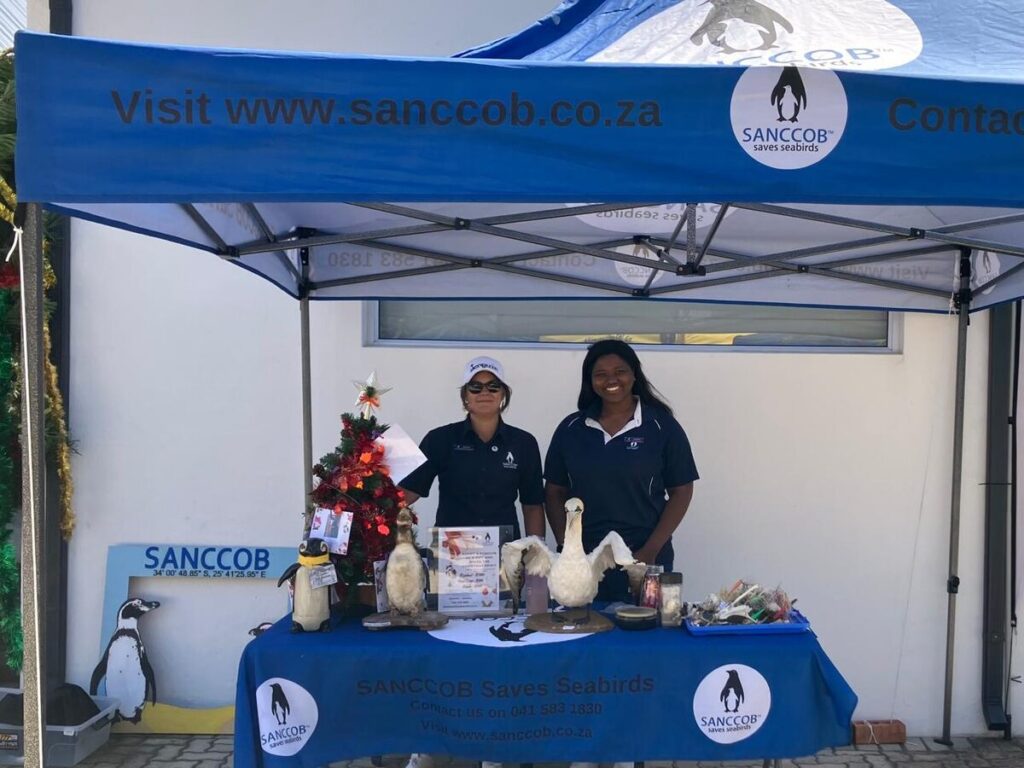 Two people standing a stall.