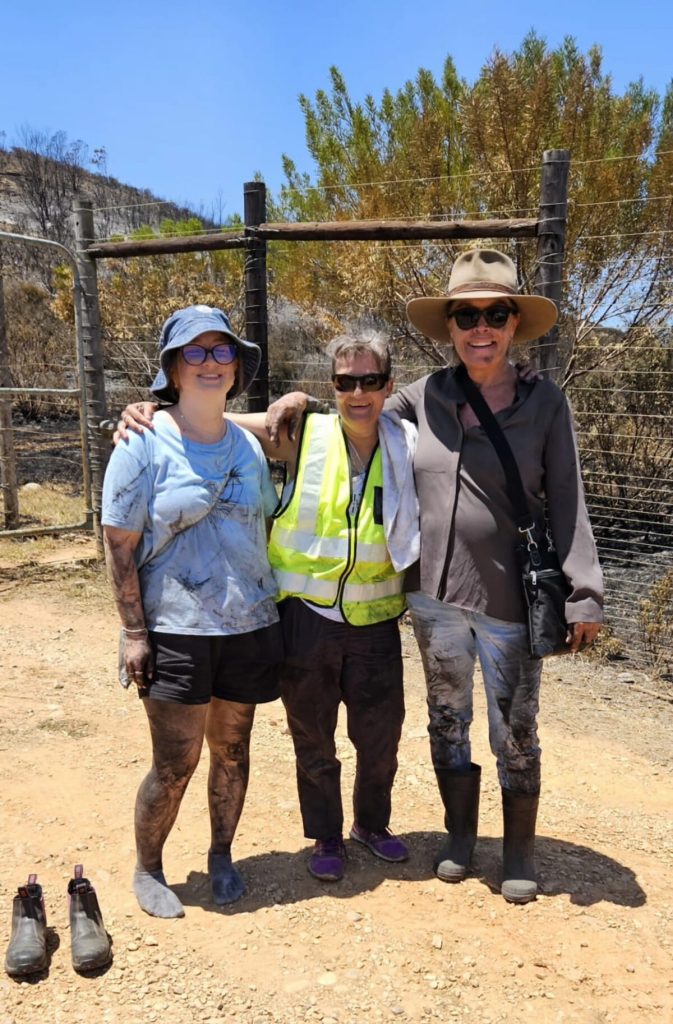 A group of volunteers standing alongside each other.